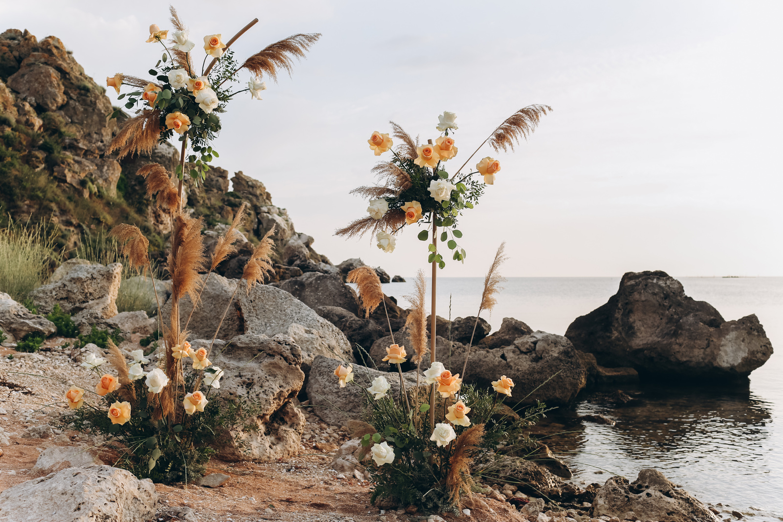 Wedding arch of roses in boho style. Boho eco wedding.